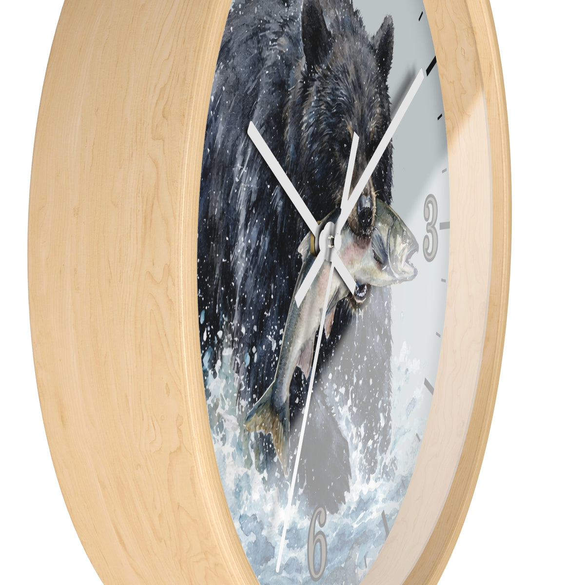 Round wall clock with a light natural wood frame and a printed dial showing a black bear catching a fish in splashing water, photographed on a white background.