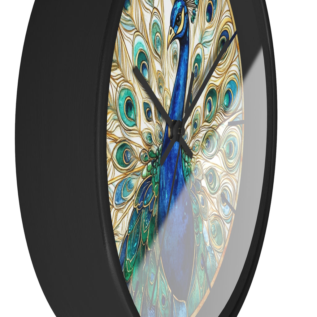 A close-up of a round wall clock with a black frame and a peacock design on the face. The peacock artwork features a bright blue neck and body with green and teal feathers and gold eye-like patterns, set against a white background.