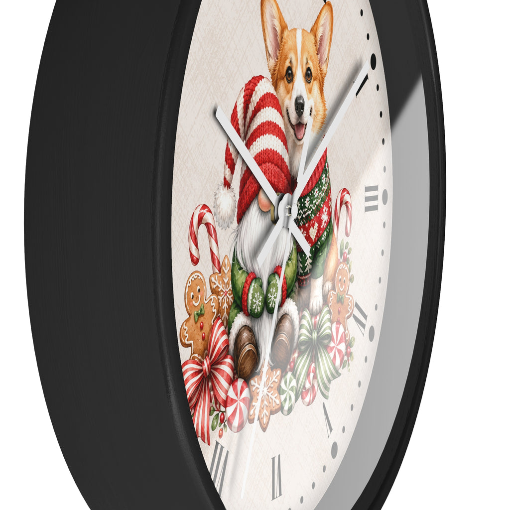 A round wall clock with a black frame and a white face featuring a corgi dog dressed in a red-and-white Santa hat and green scarf, surrounded by Christmas illustrations including candy canes, gingerbread cookies, and bows.