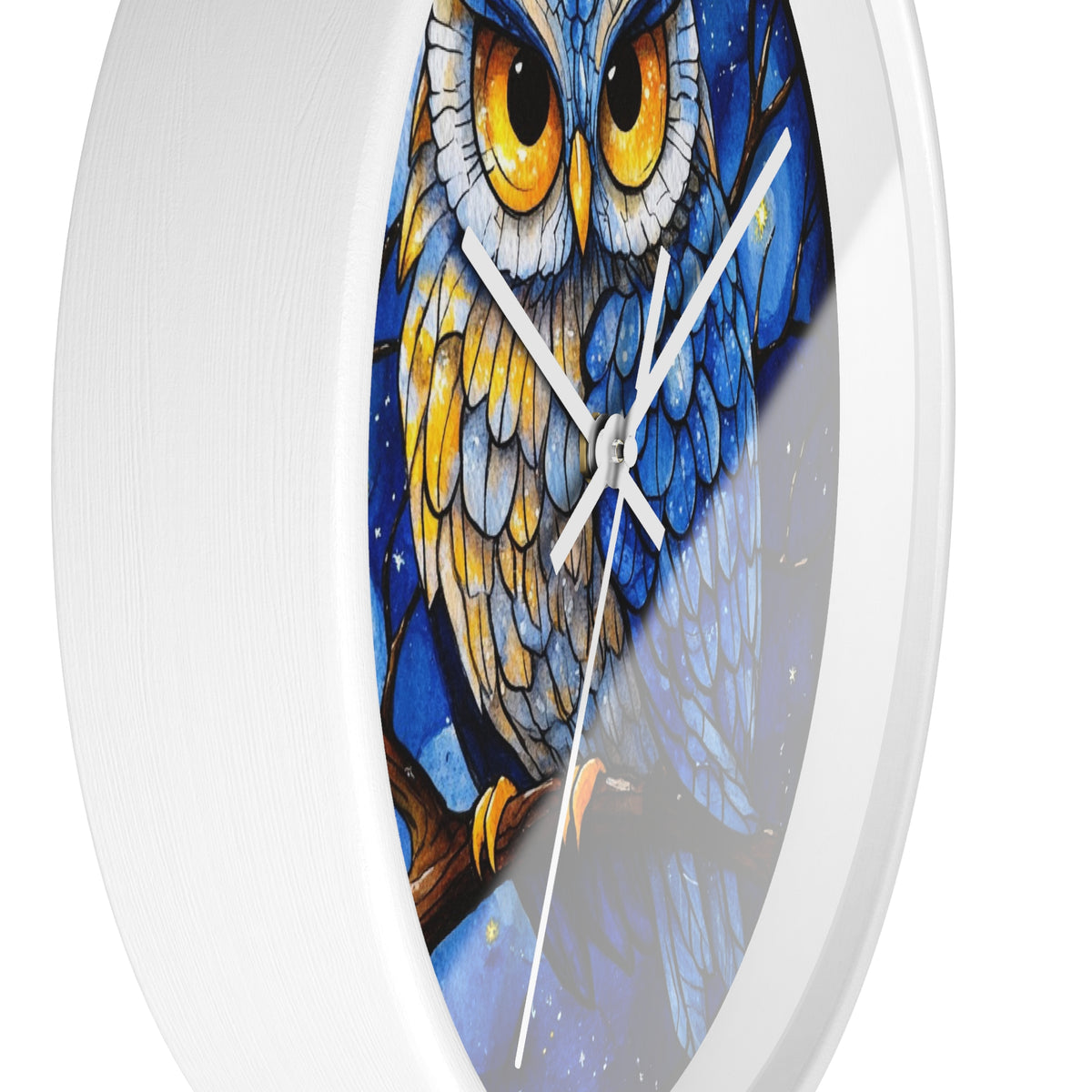 Round wall clock with a white frame and a printed owl illustration on the face. The owl has large yellow eyes, blue and gray feathers, and is perched on a brown branch against a dark blue starry background.