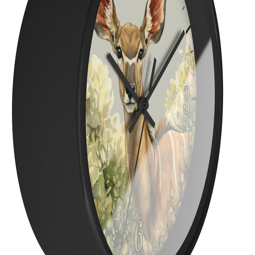 A round wall clock with a black frame and a printed antelope illustration on the face, photographed against a plain white background.