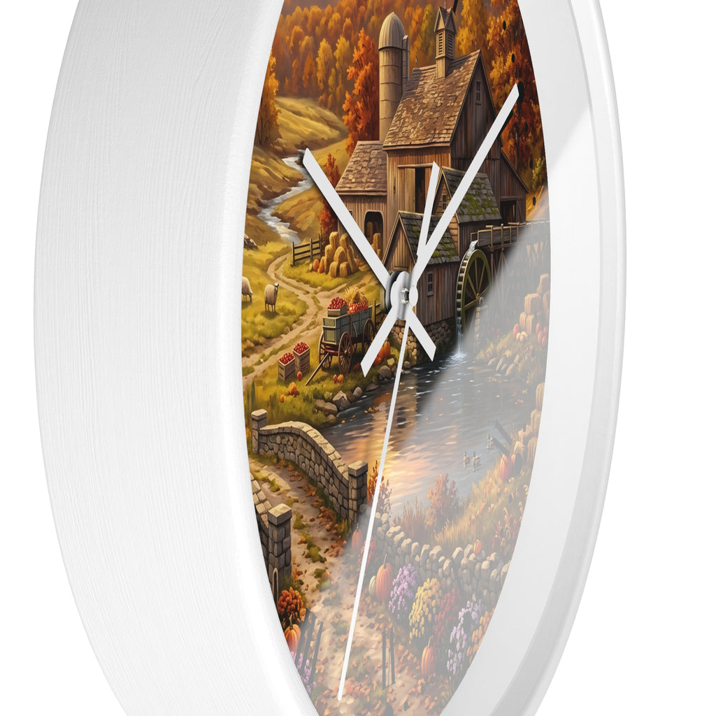 Round wall clock with a white frame and a printed autumn farm landscape design featuring a barn, water wheel, stone bridge, and colorful fall foliage.