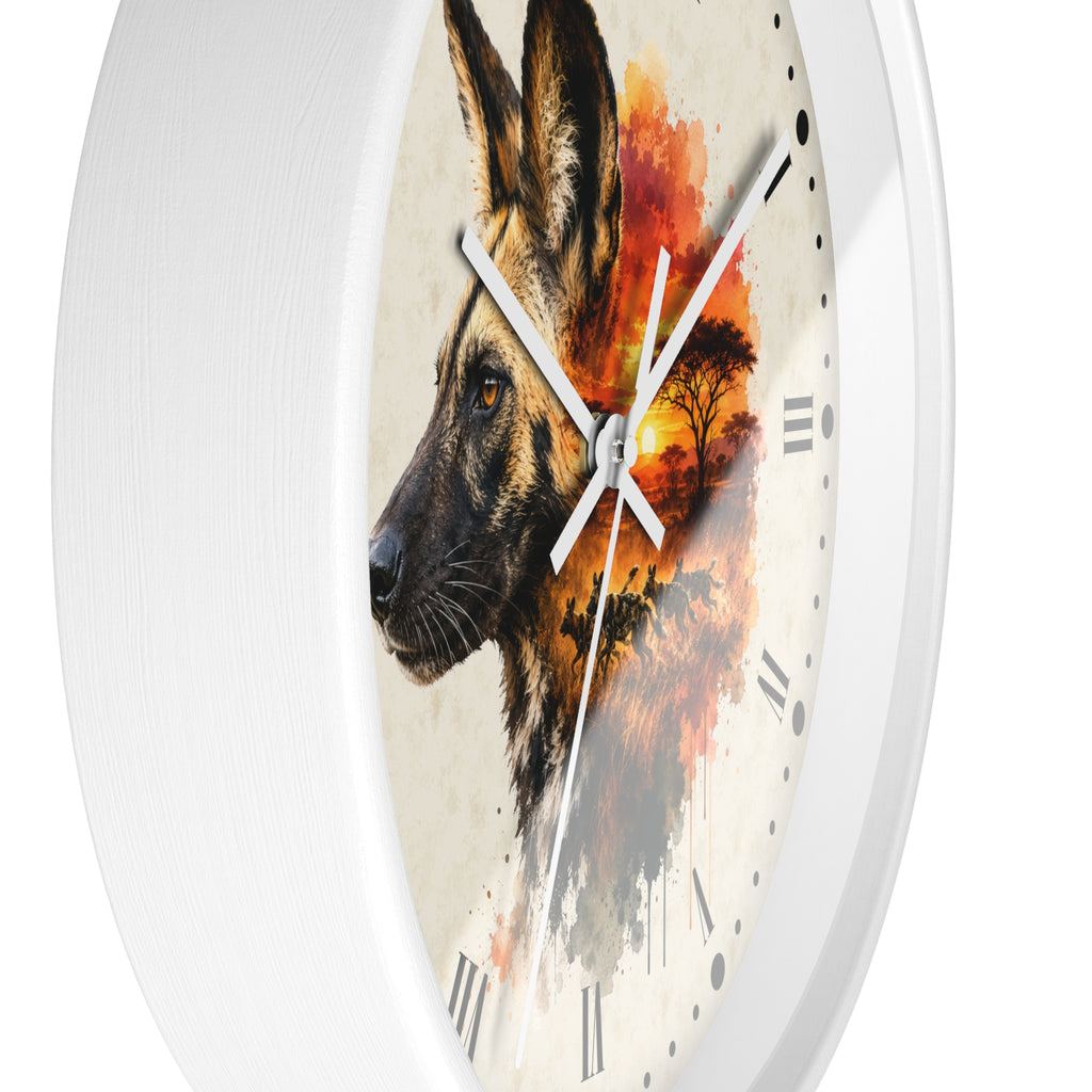 A round white wall clock with a printed design of a African wild dog's head layered over an orange and red sunset landscape on the clock face.
