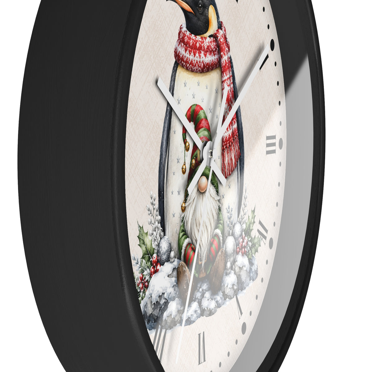 A close-up of a round wall clock with a black frame and a white face featuring a penguin wearing a red-and-white striped scarf and a gnome in the snow below, shown against a white background.