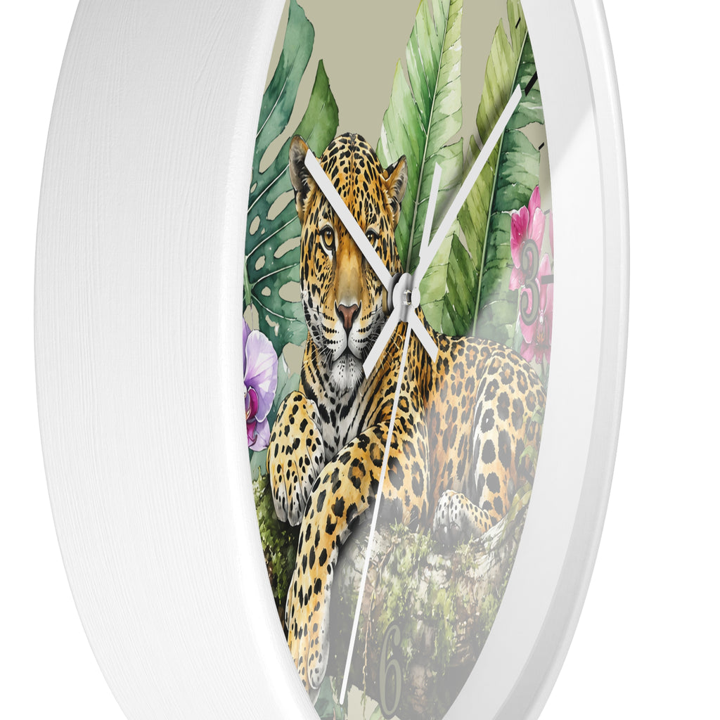 Round wall clock with a white frame and a printed tropical jungle scene featuring a leopard, green leaves, and pink flowers on the face.