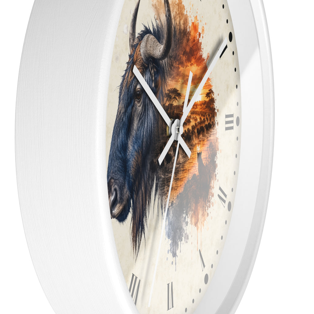 A round wall clock with a white frame and a printed face featuring a detailed blue wildebeest head on the left and an orange-toned savanna landscape on the right, with white hands and black Roman numerals.