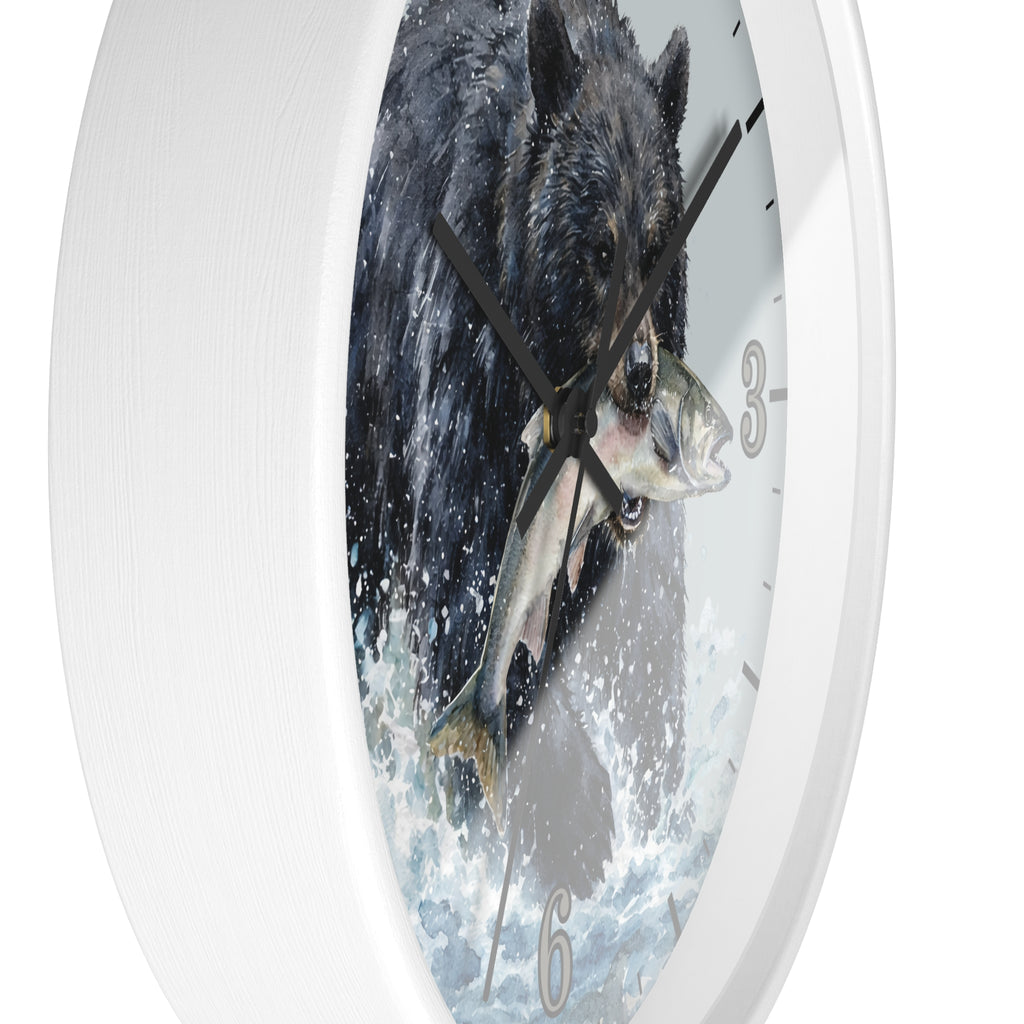 A white round wall clock with a printed design of a black bear catching a fish in the center, shown against a plain white background.