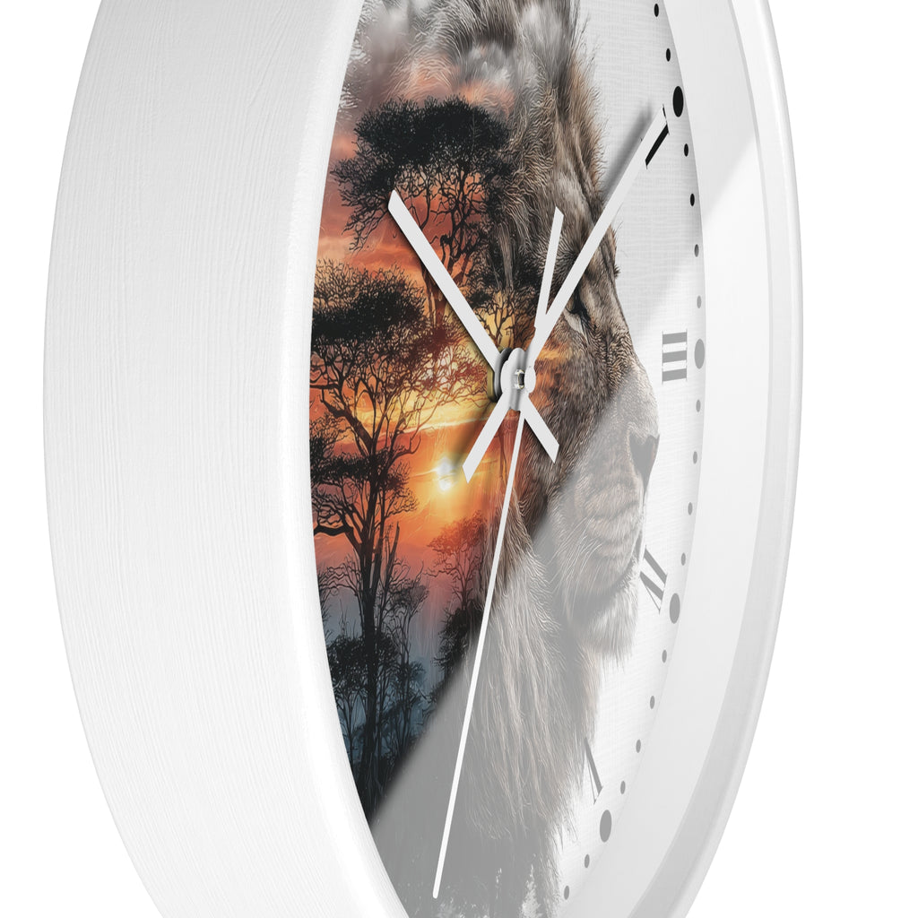 A close-up of a round wall clock with a white frame and a printed design featuring a lion face blended with an African savanna sunset scene. The clock has white hands, black Roman numerals, and black dot hour markers on a clean white background.