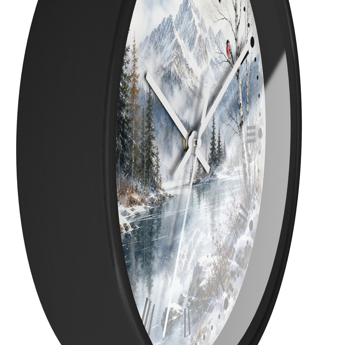 A round wall clock with a black frame and a printed winter mountain landscape face, featuring snowy peaks, trees, a frozen river, and white clock hands.