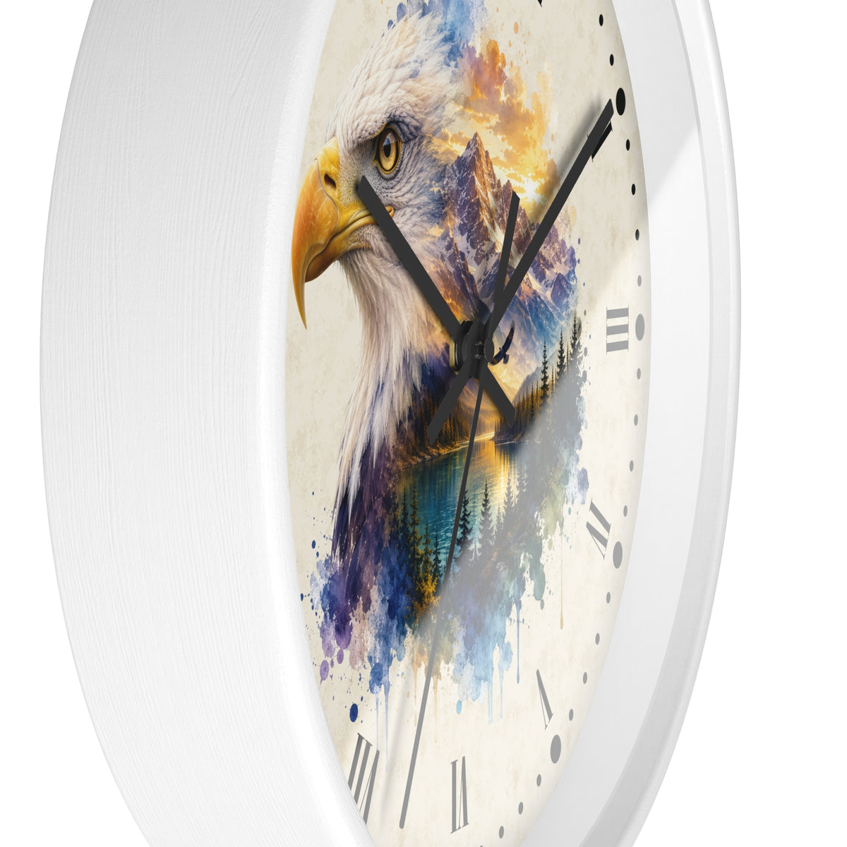 A round wall clock with a white frame and a printed face featuring a watercolor-style bald eagle over blue mountains and trees. The clock has black Roman numerals and black hands, shown against a plain white background.