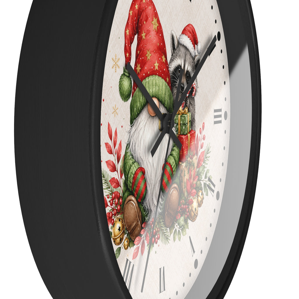 A round wall clock with a black frame and a white face featuring a festive illustration of a gnome and a raccoon in Christmas attire, shown against a plain white background.