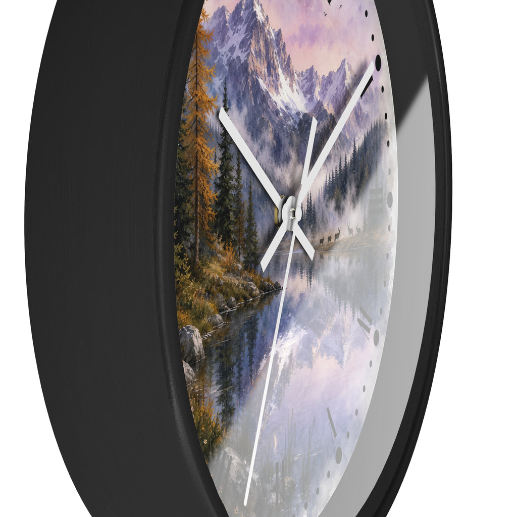Round wall clock with a black frame and a scenic landscape print of a mountain lake at sunrise, and a herd of deer, shown against a white background.