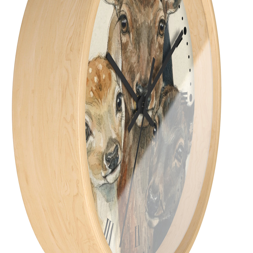 Round wall clock with a light natural wood frame and a printed face featuring painted deer and a fawn, shown on a white background.