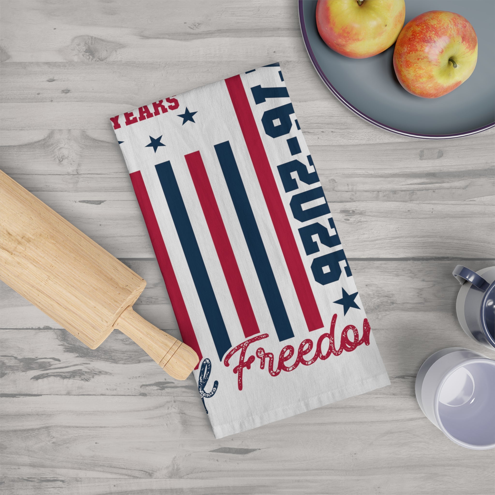 Tea towel with American flag design and 'Freedoms' text on a kitchen counter.