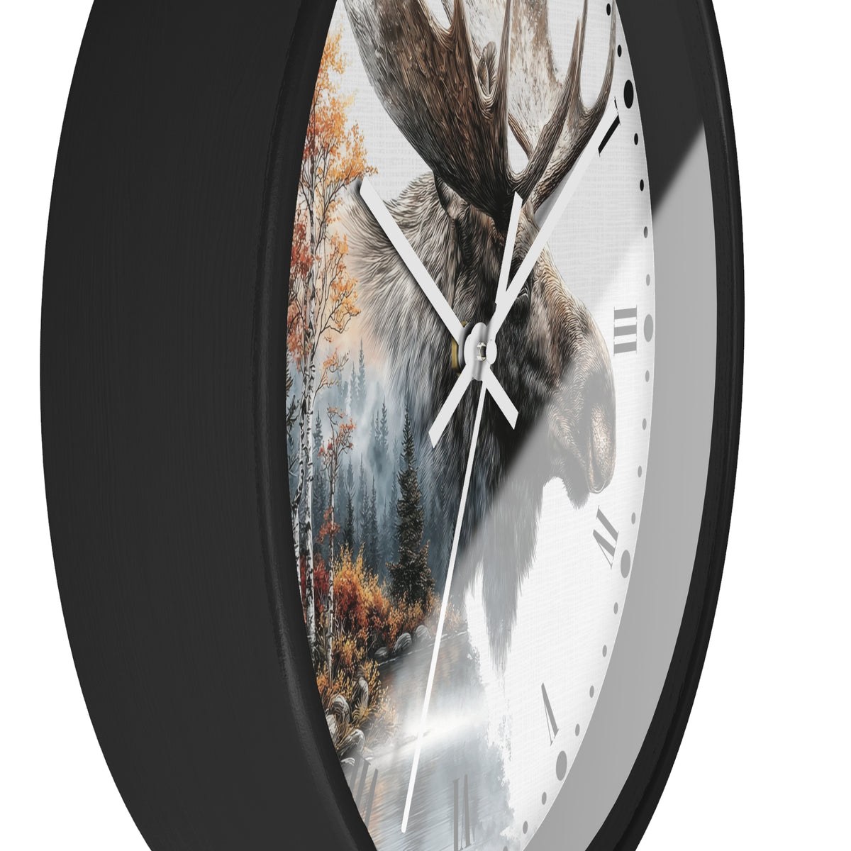 A close-up of a round wall clock with a black frame and a printed nature design on the face, showing a moose head over a forest scene with autumn trees and a snowy path. The clock has white hands, black Roman numerals, and a white reflective lower half.