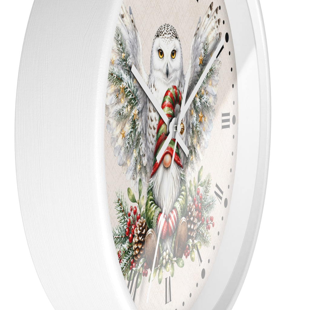 A round white wall clock featuring a festive illustration of a snowy owl wrapped in a red and green striped scarf, surrounded by pine branches, candy canes, and red berries on a cream dial.