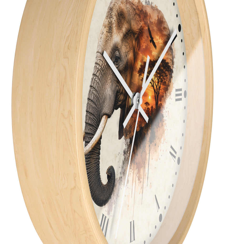 A round wall clock with a light natural wood frame and a clock face featuring a detailed elephant illustration over a warm sunset scene, shown on a plain white background.