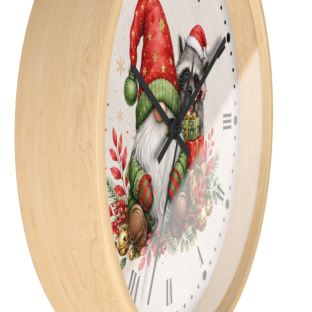 A round wall clock with a light natural wood frame and a white clock face featuring a festive illustration of a raccoon dressed as Santa Claus, surrounded by green leaves, red berries, and holiday decorations.