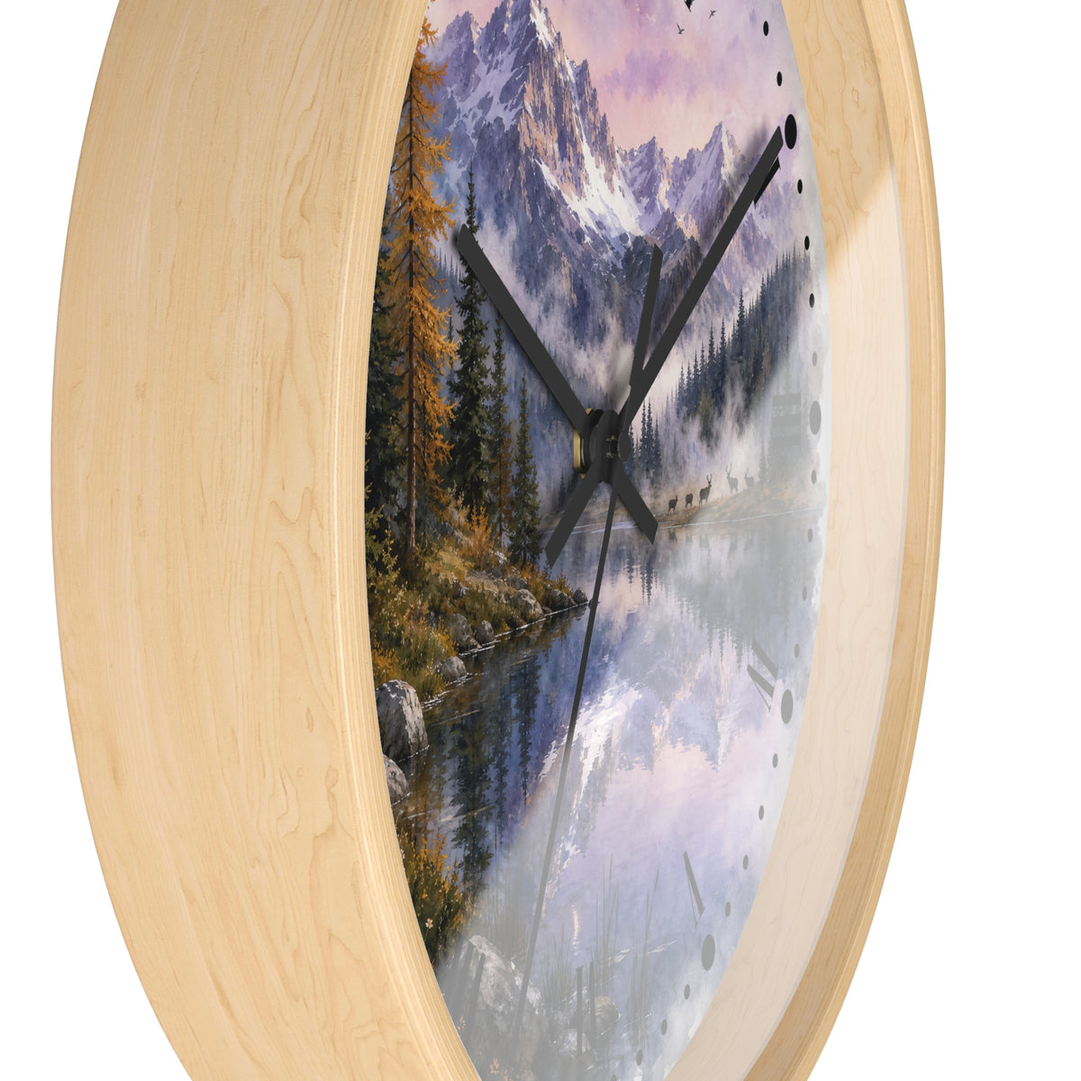 Round wall clock with a light natural wood frame and a scenic landscape print featuring a mountain lake, pine trees, a herd of deer, and a purple-toned sky.