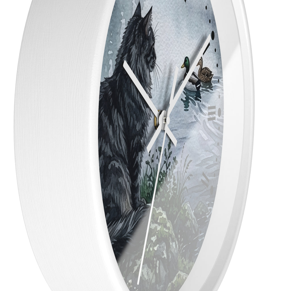 Round white wall clock featuring a printed illustration of a black cat beside ducks on water, with white clock hands and a white outer rim.