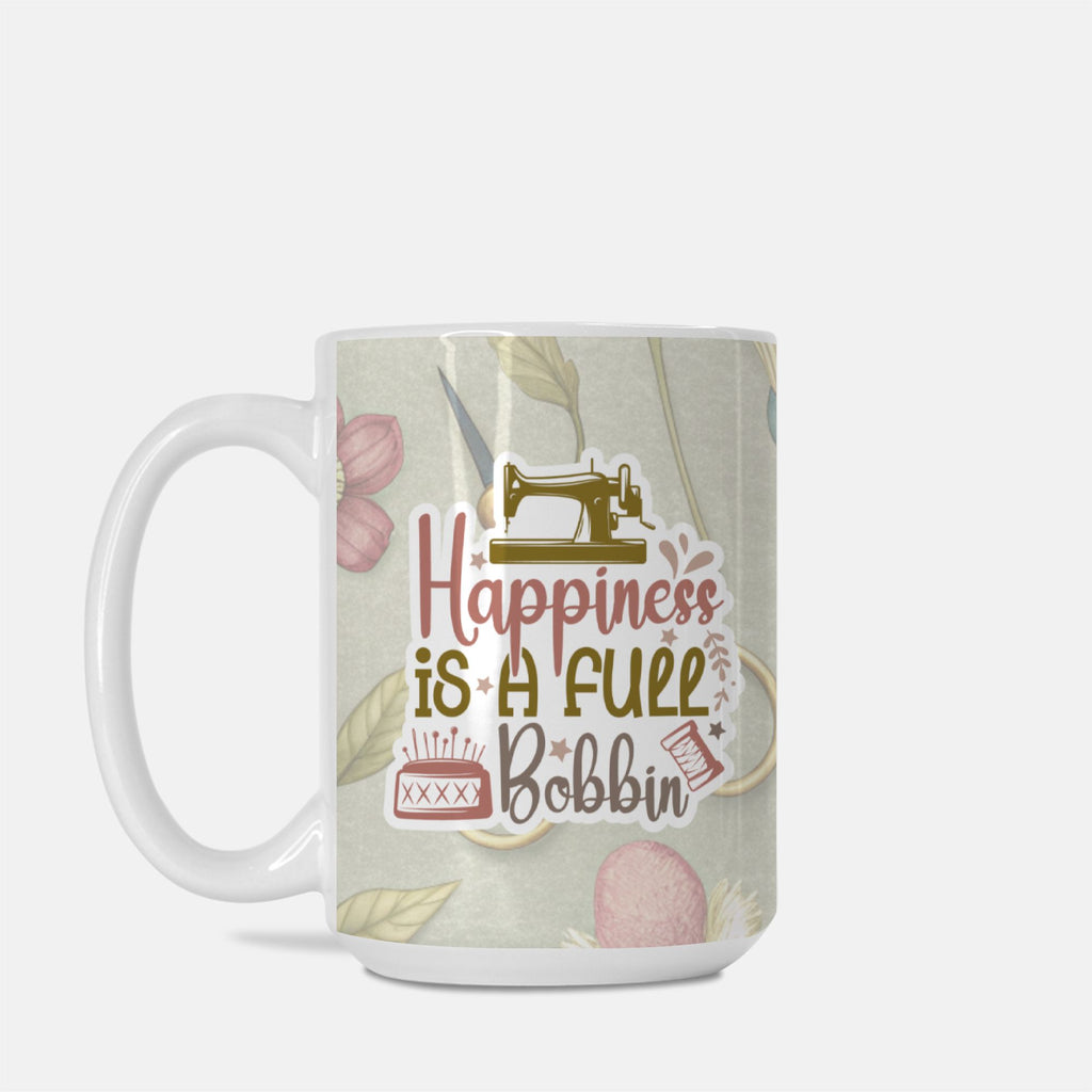 Mug with sewing-themed design and text 'Happiness is a full bobbin' on a light background
