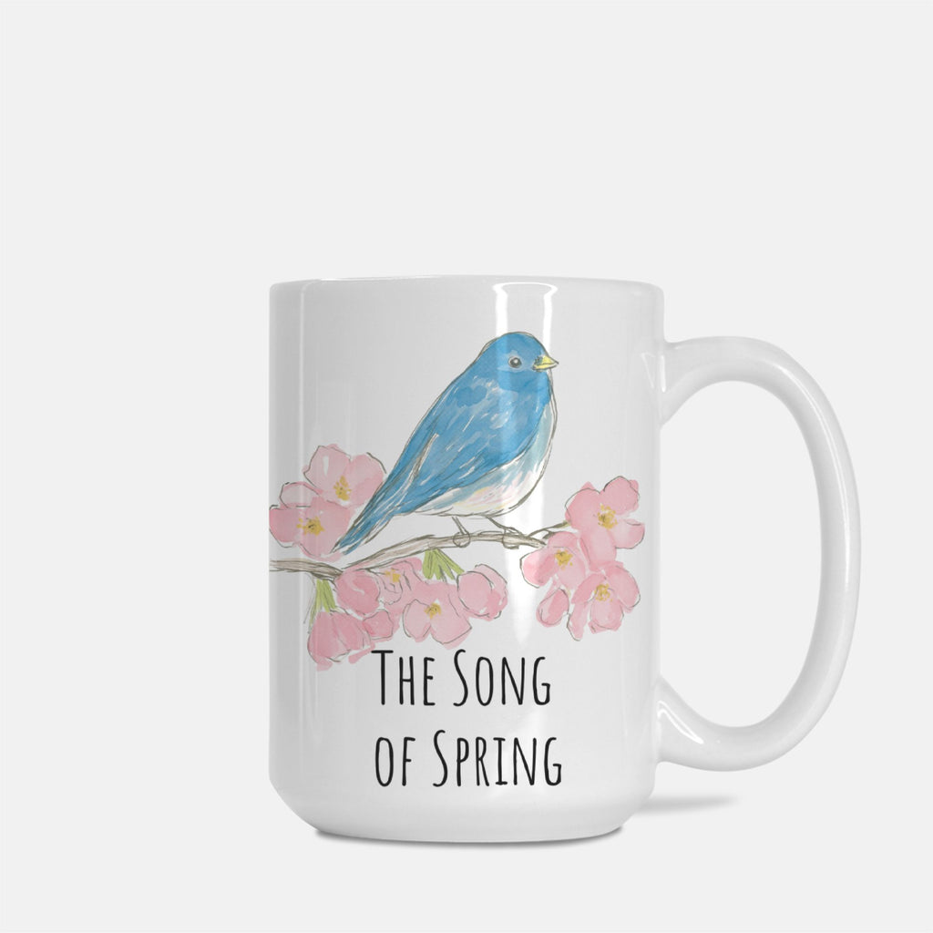 Mug with a blue bird and cherry blossoms design on a white background