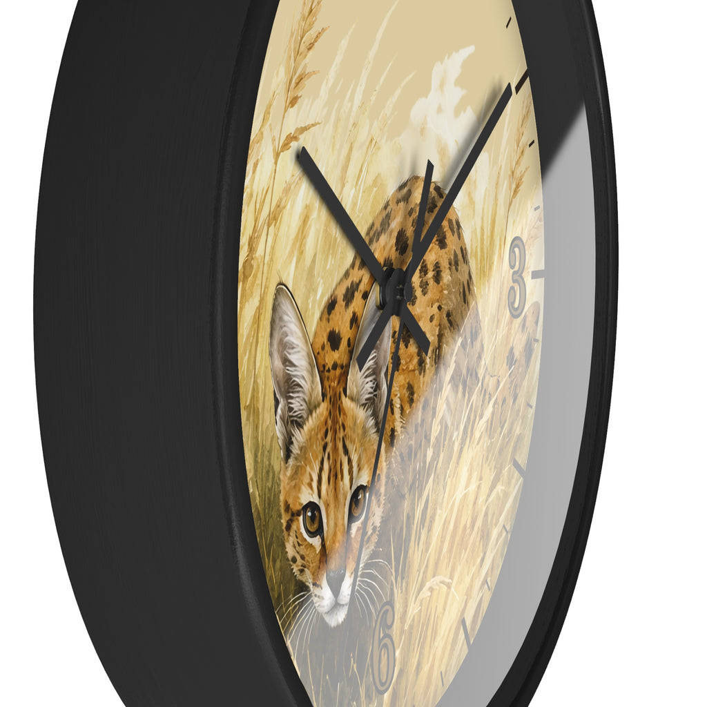 A round wall clock with a black frame and a printed dial showing a spotted big cat in a golden grassy scene. The clock is shown at an angle against a plain white background.