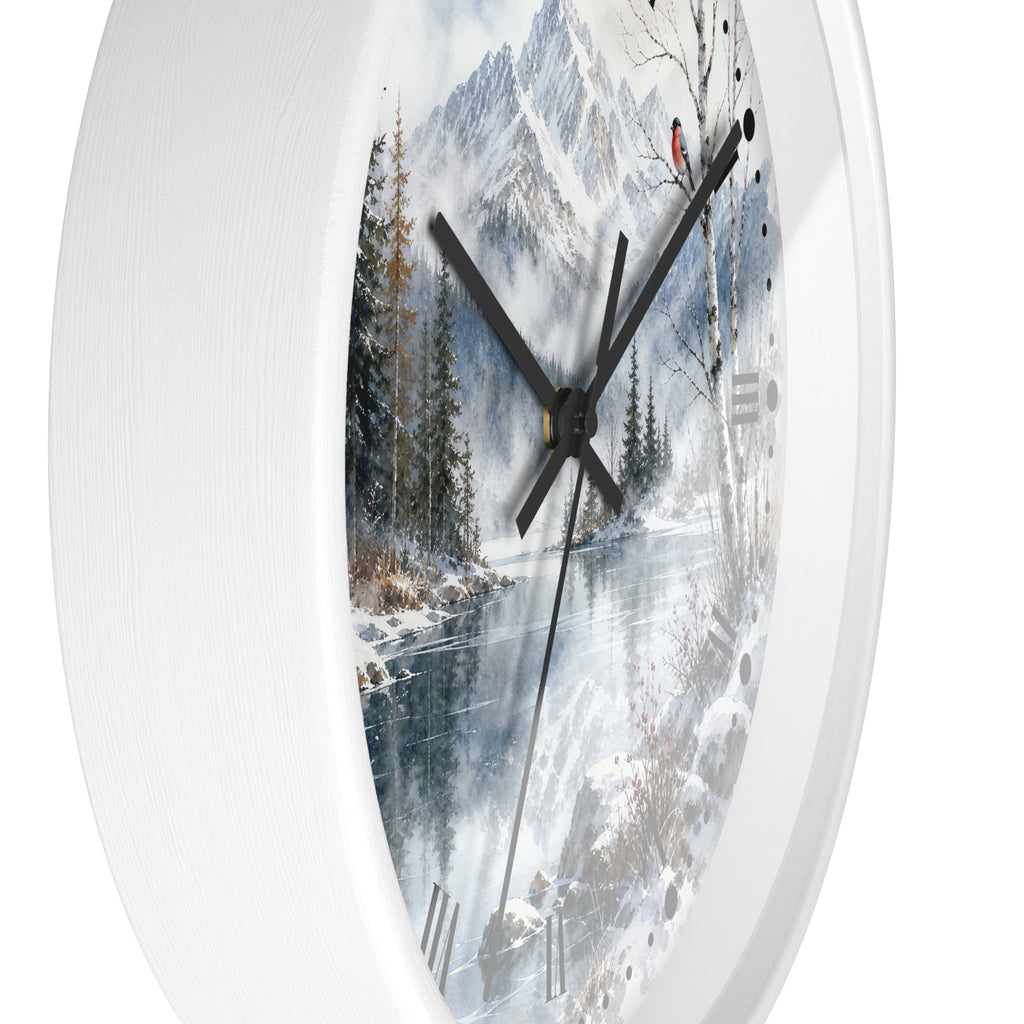 A white round wall clock with a printed winter landscape design on the face, featuring snowy mountains, trees, and a river, with black hands.