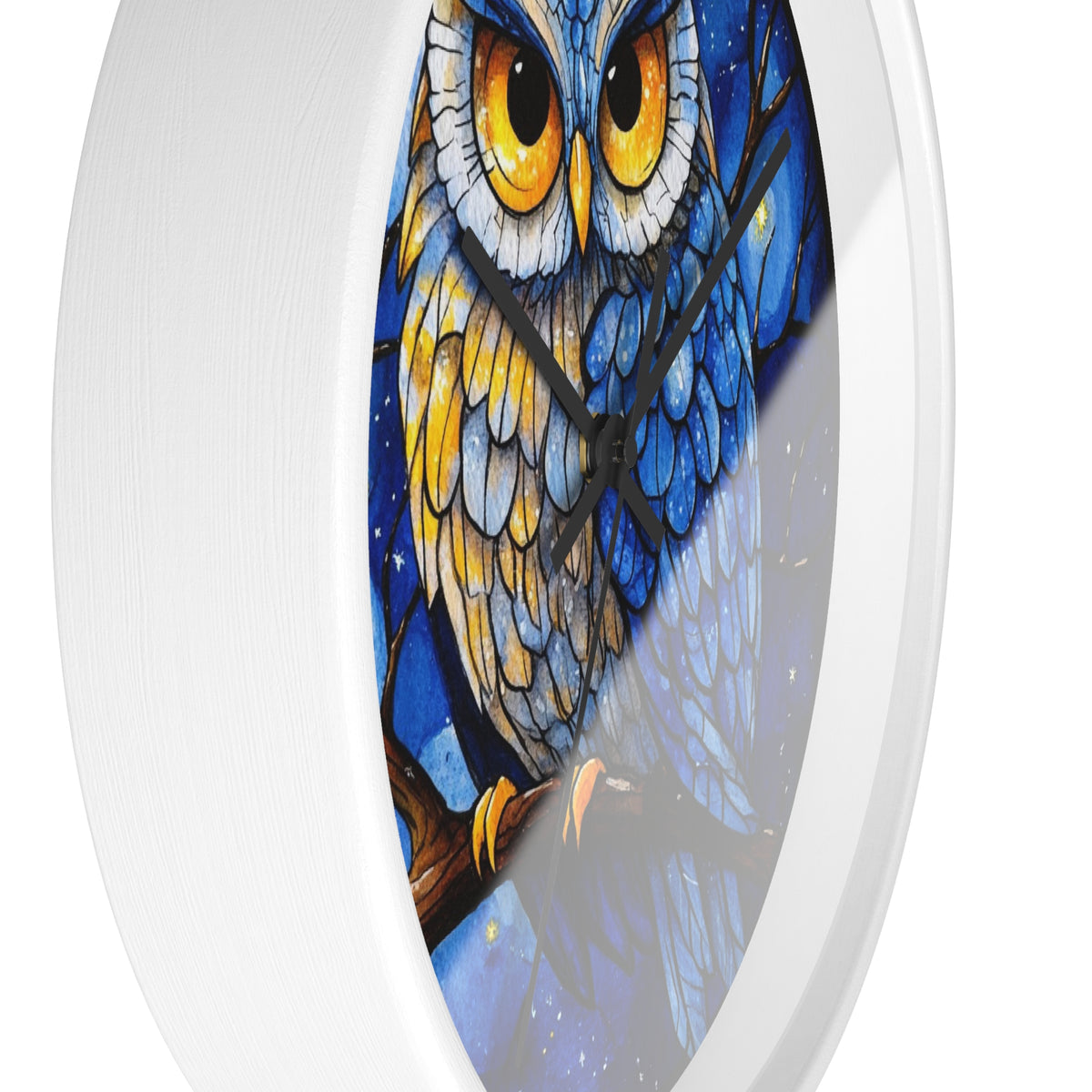 Round wall clock with a white frame and a printed owl illustration on the face. The owl has large yellow eyes, blue and white feathers, and is perched on a branch against a dark blue night-sky background.