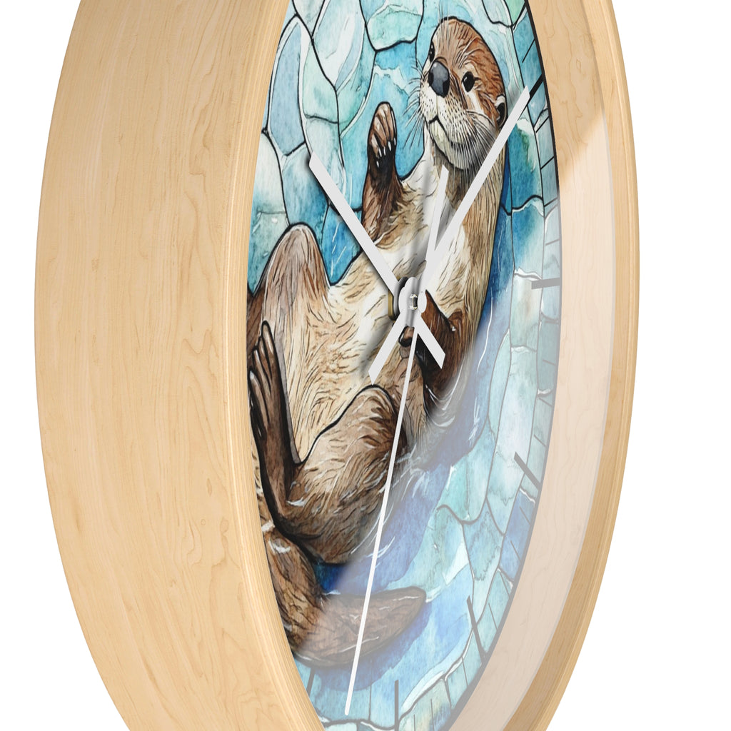 Round wall clock with a light natural wood frame and a stained-glass-style illustration of an otter in blue and white tones on the face.