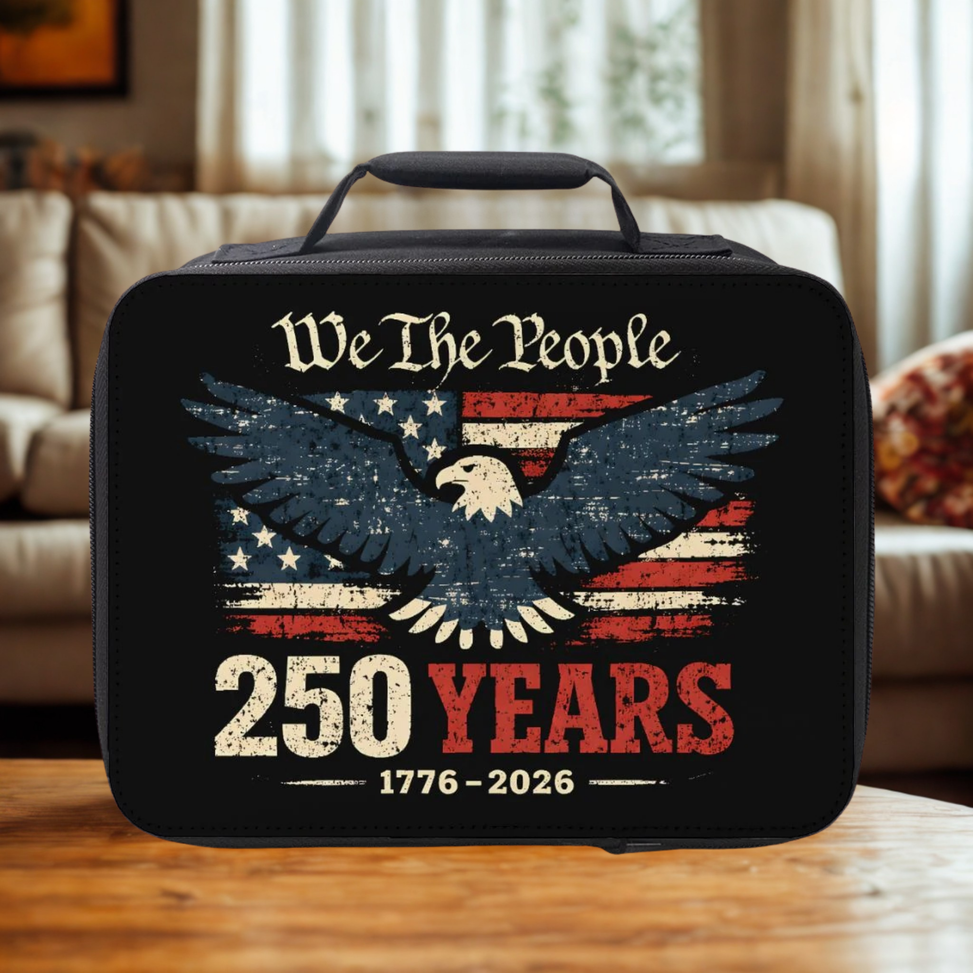 Black lunch bag with American flag and eagle design on a wooden table.