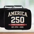 Black lunch bag with 'America 250 Years of Greatness' text on a blurred background