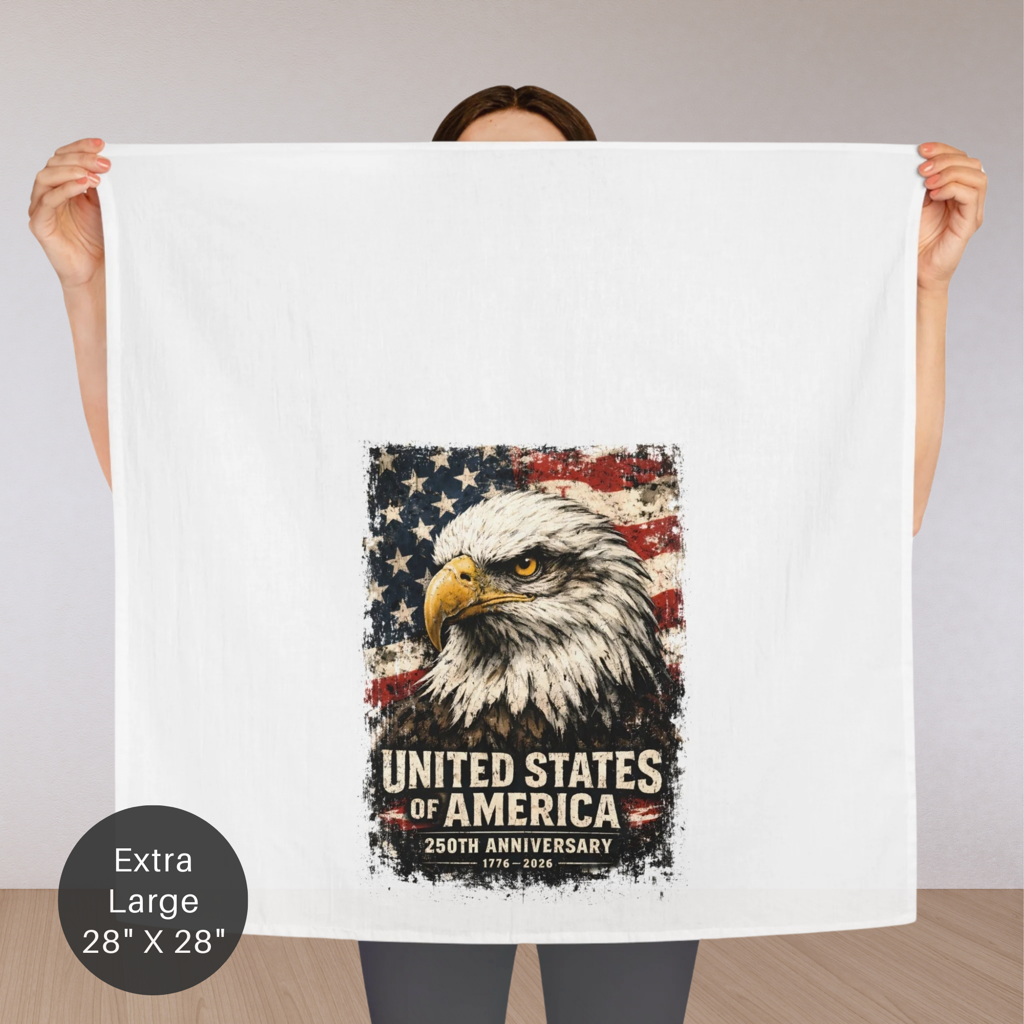 Person holding an extra large tea towel with an eagle and American flag design, celebrating the 250th anniversary of the United States.