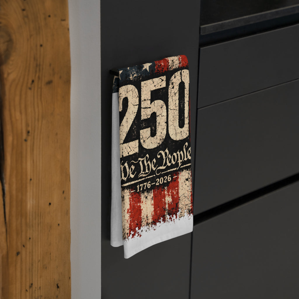 Book titled '250 We The People 1776-2026' with a distressed design on a black surface.