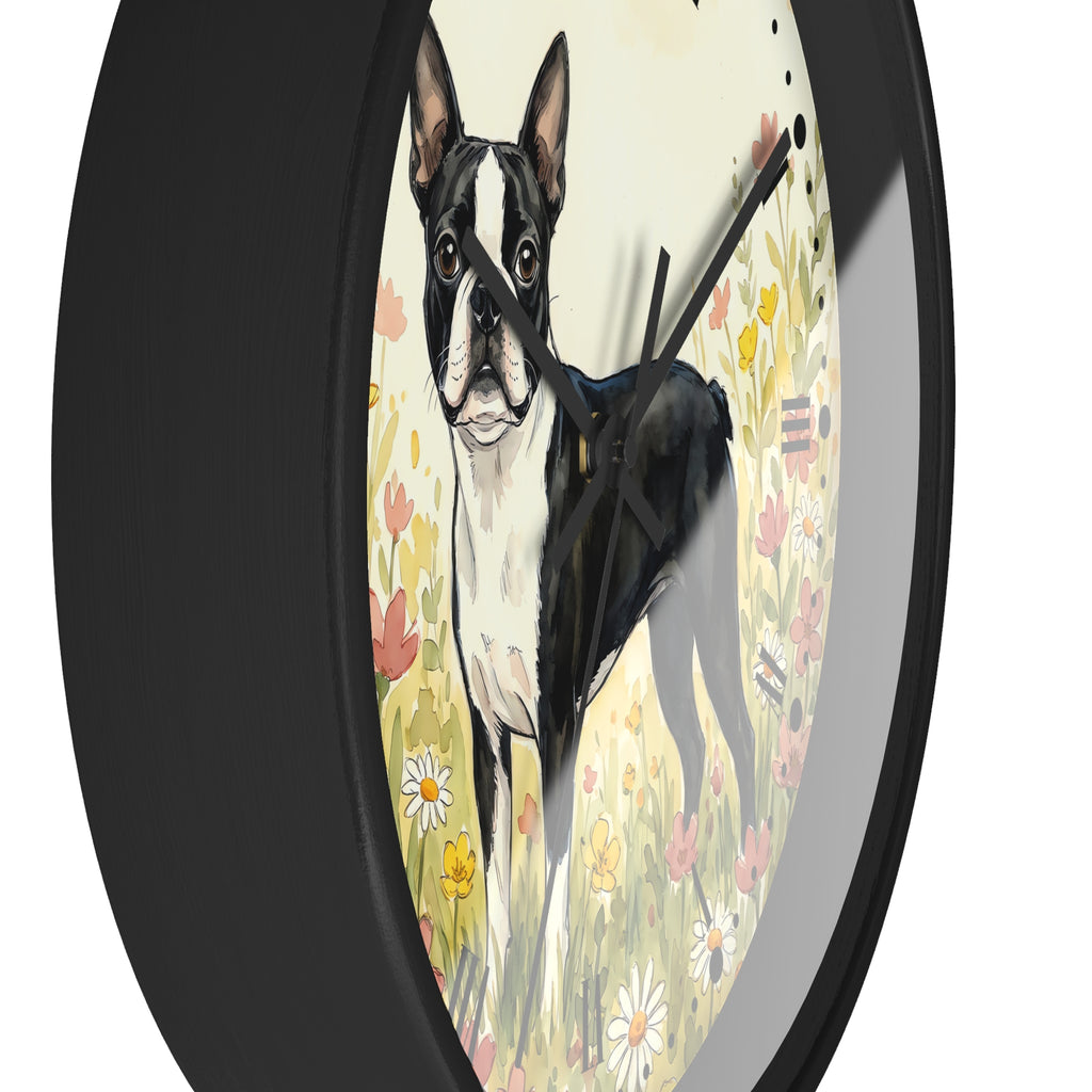 A round wall clock with a black frame and black hands, featuring an artistic illustration of a black and white Boston Terrier standing in a field of yellow, pink, and white flowers against a cream background.