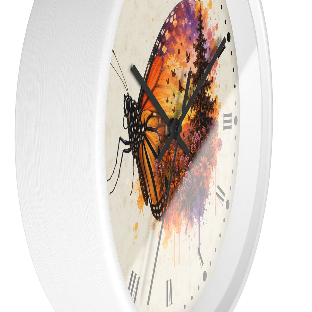 A close-up of a round wall clock with a white frame and a printed face featuring a large orange-and-black butterfly over a colorful watercolor background with black Roman numerals and black hands.