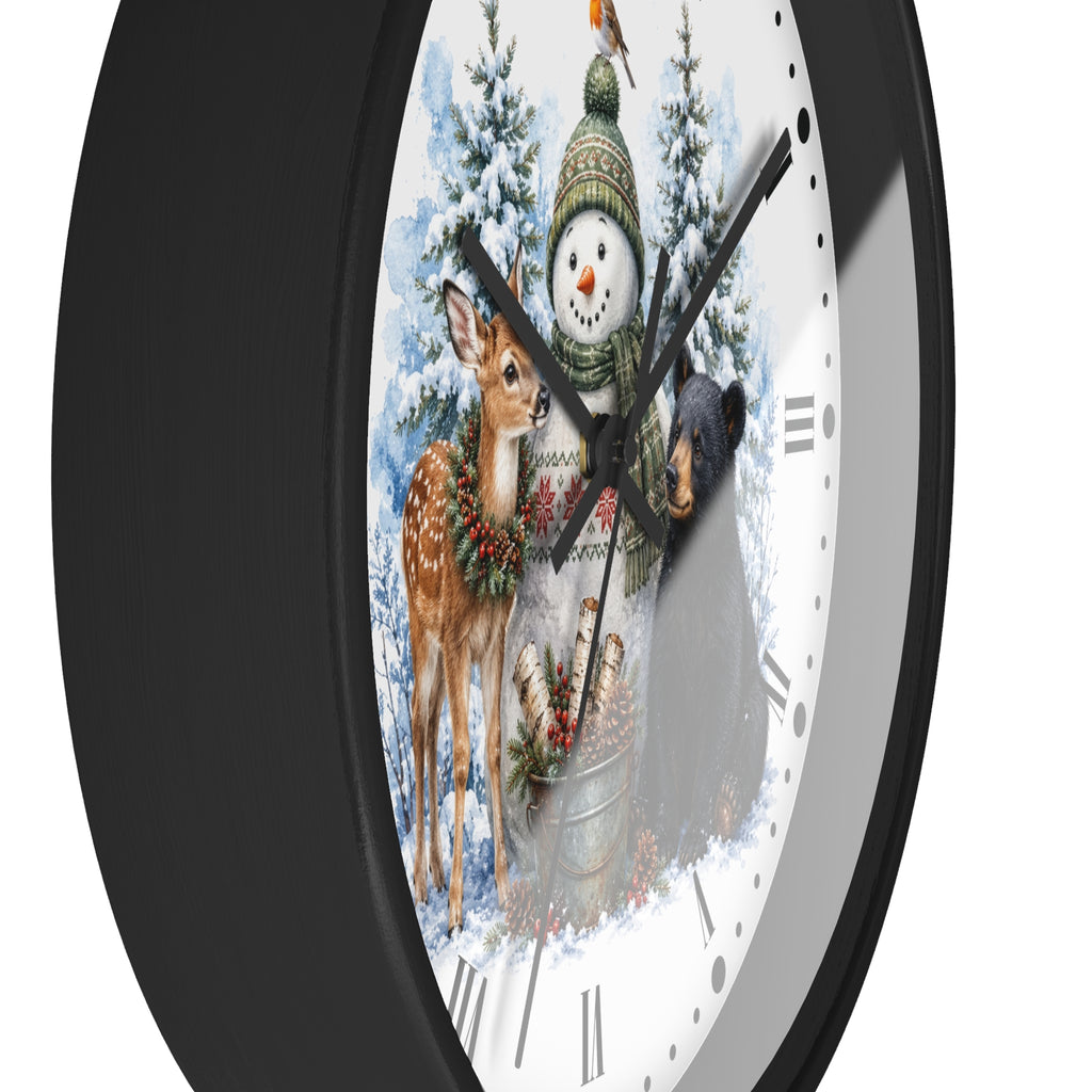 A round wall clock with a black frame and a white face featuring a winter holiday illustration of a snowman, deer, bear, and snowy trees.