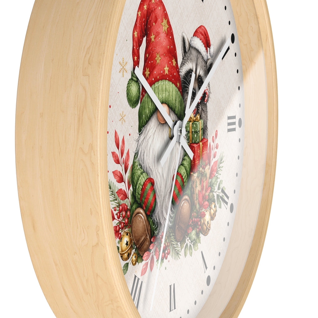 A round wall clock with a light natural wood frame and a white clock face featuring a festive Christmas illustration of a raccoon in a Santa hat alongside a gnome, red berries, pinecones, and green foliage.