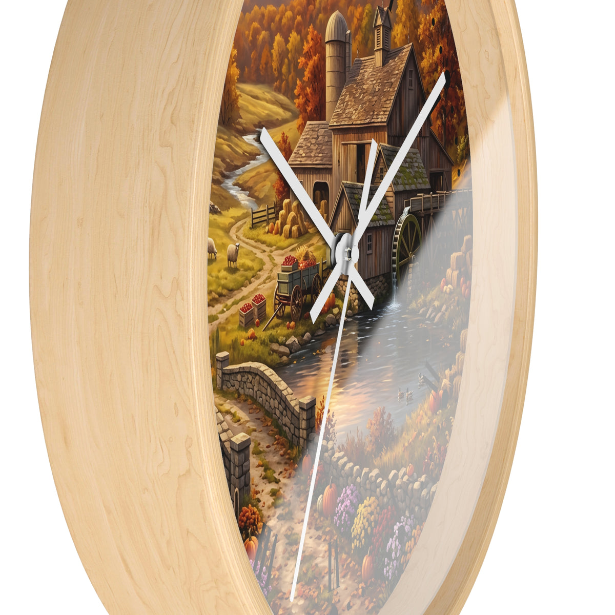 Round wall clock with a light natural wood frame and a scenic landscape print showing a rustic mill, water wheel, stone bridge, and autumn foliage. White clock hands are visible against a plain white background.