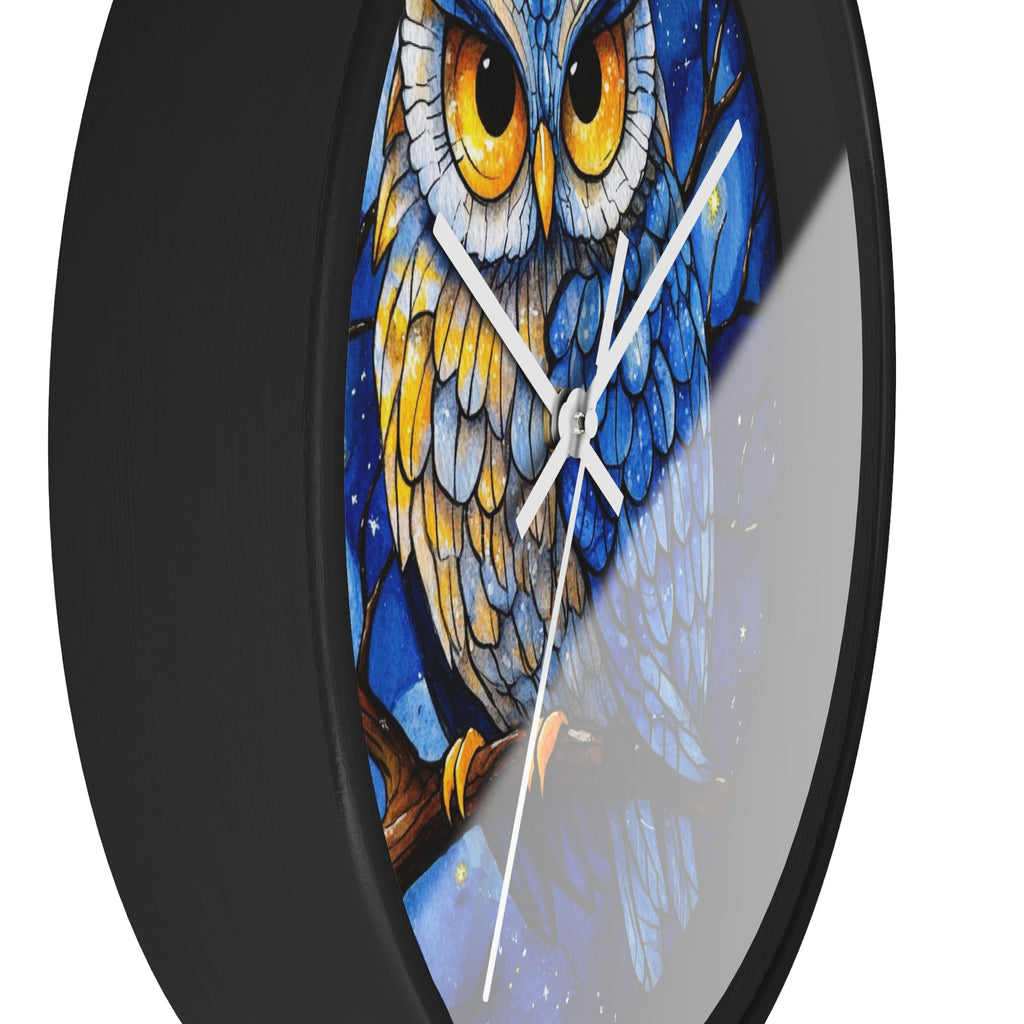 Round wall clock with a black frame and a colorful stained-glass style owl illustration featuring blue, yellow, and white tones.