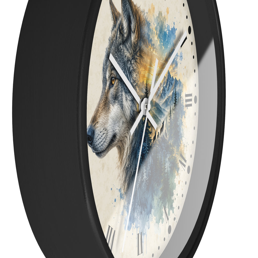 A close-up of a round wall clock with a black frame and a printed wolf illustration on the face. The design shows a gray and white wolf over blue and yellow watercolor-style mountain scenery, with white clock hands and Roman numeral hour markers.