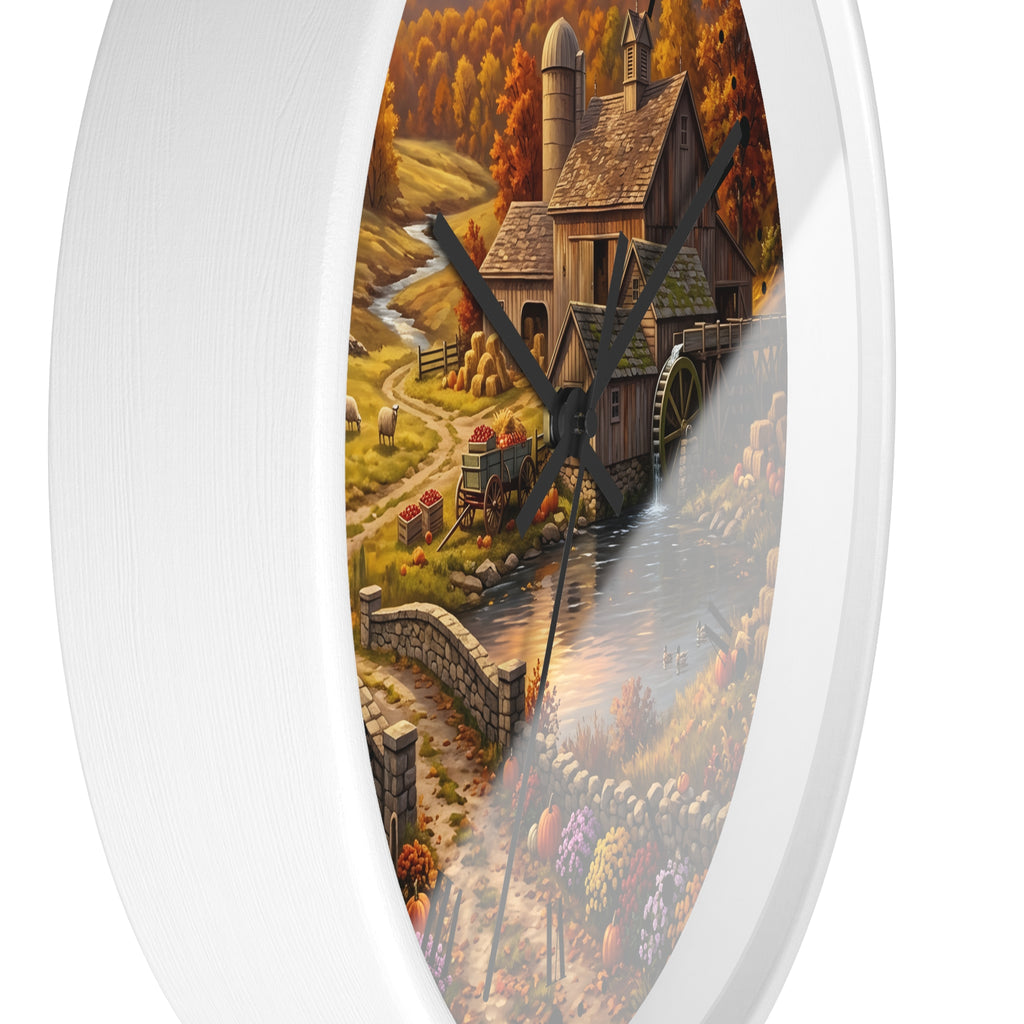 Round wall clock with a white frame and a printed autumn farm scene on the face, featuring a wooden mill, water wheel, crops, and a stream. The clock is shown against a plain white background.