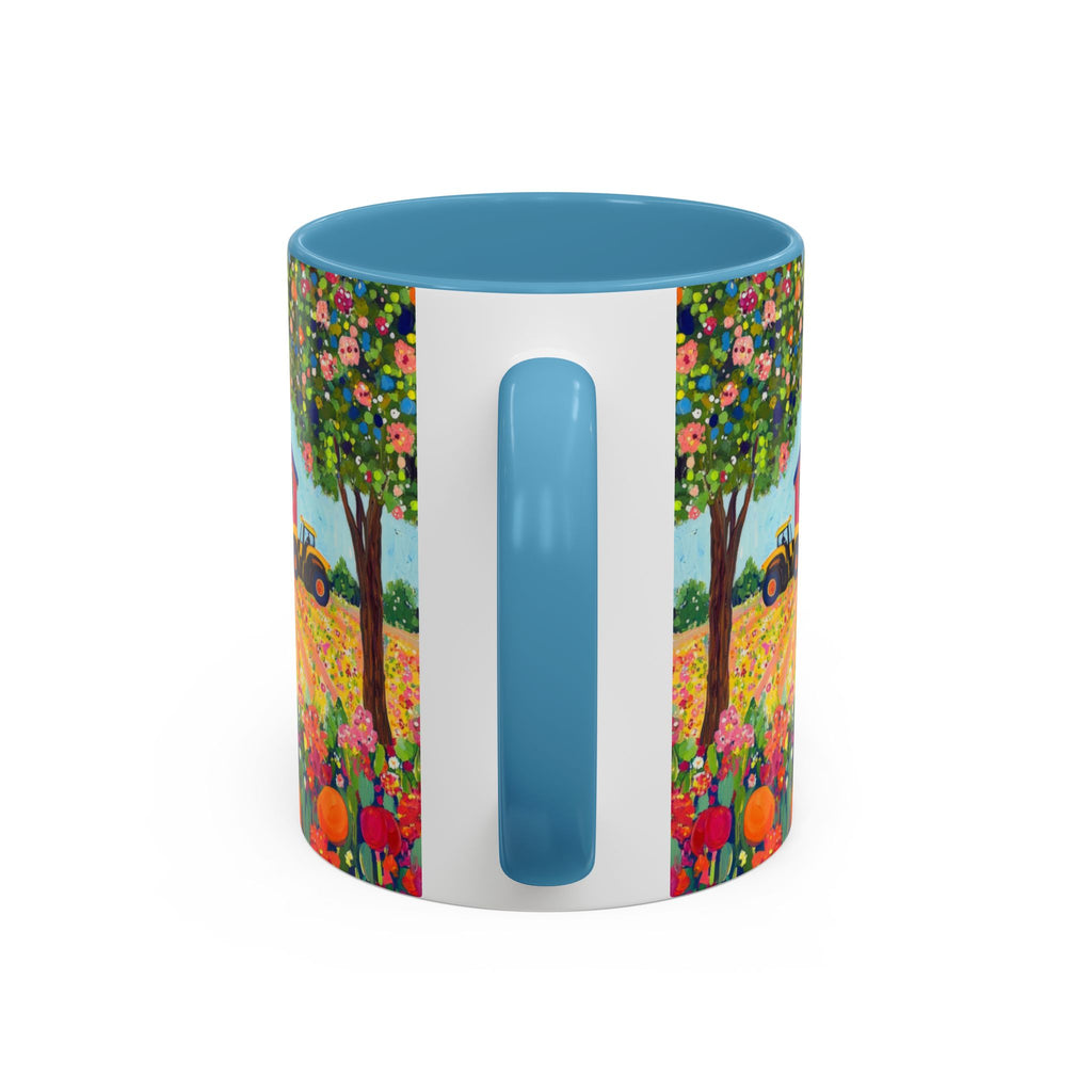Colorful mug with floral design and blue handle on a white background