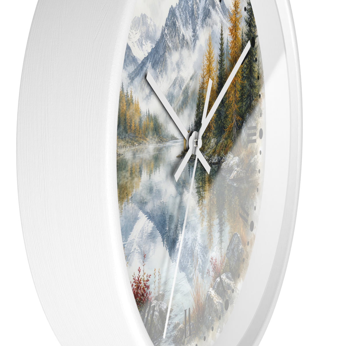 Round wall clock with a white frame and a scenic landscape print featuring mountains, a reflective lake, evergreen trees, and white clock hands.