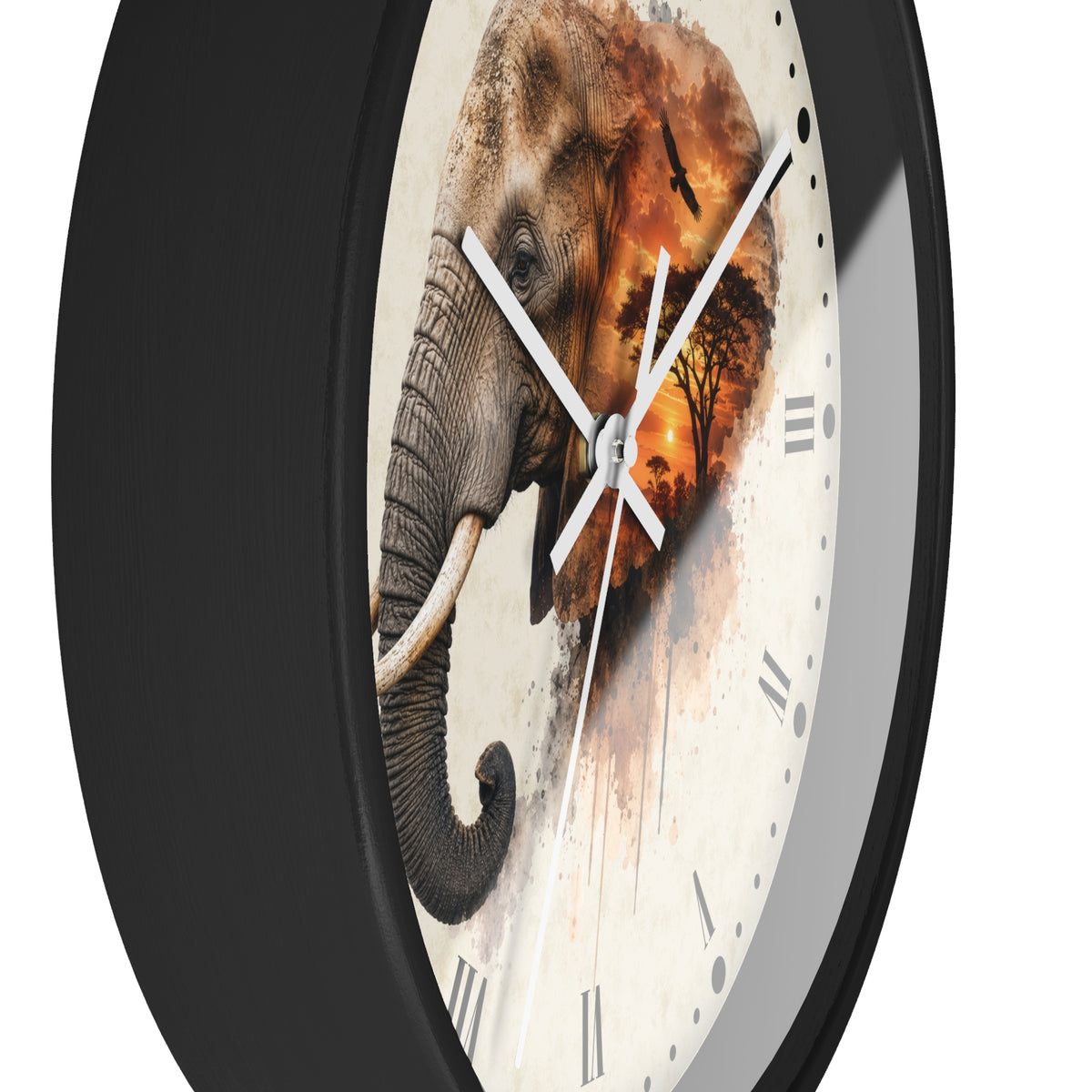 A close-up of a round wall clock with a black frame and a cream-colored face featuring a painted elephant and warm orange-brown sunset artwork. The clock has white hands and Roman numerals.