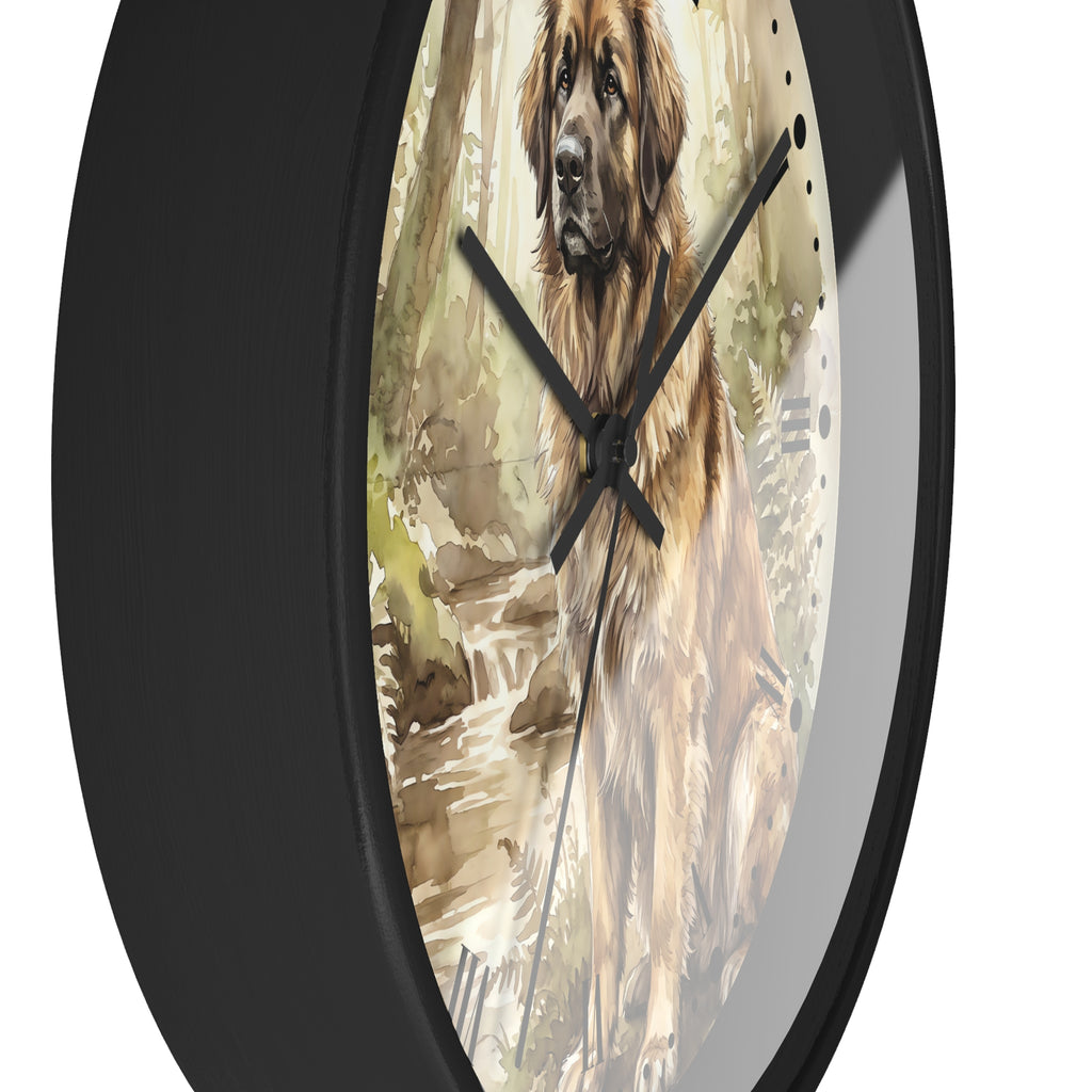 A round wall clock with a black frame and a printed watercolor-style face showing a Leonberger dog in a forest beside a stream. The clock has black hands and no visible brand text.