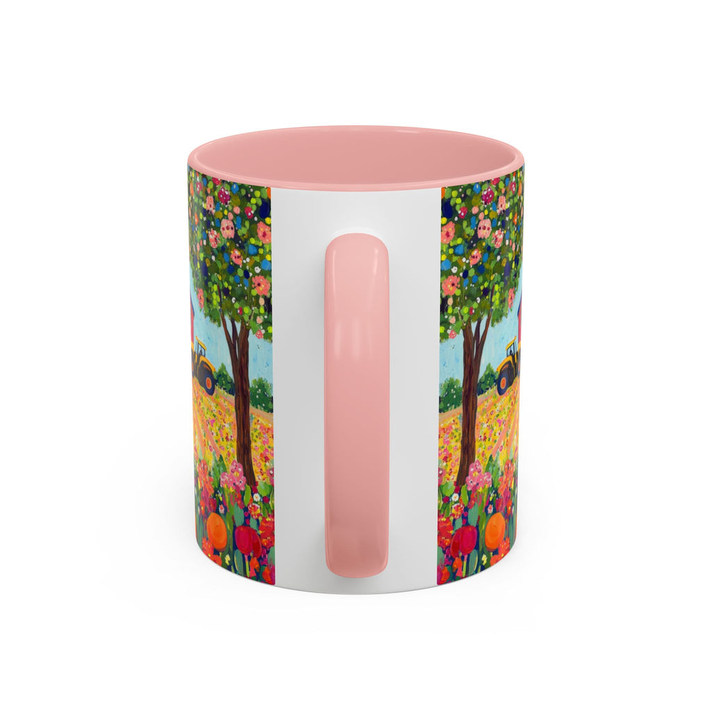 Colorful mug with floral design and pink handle on a white background