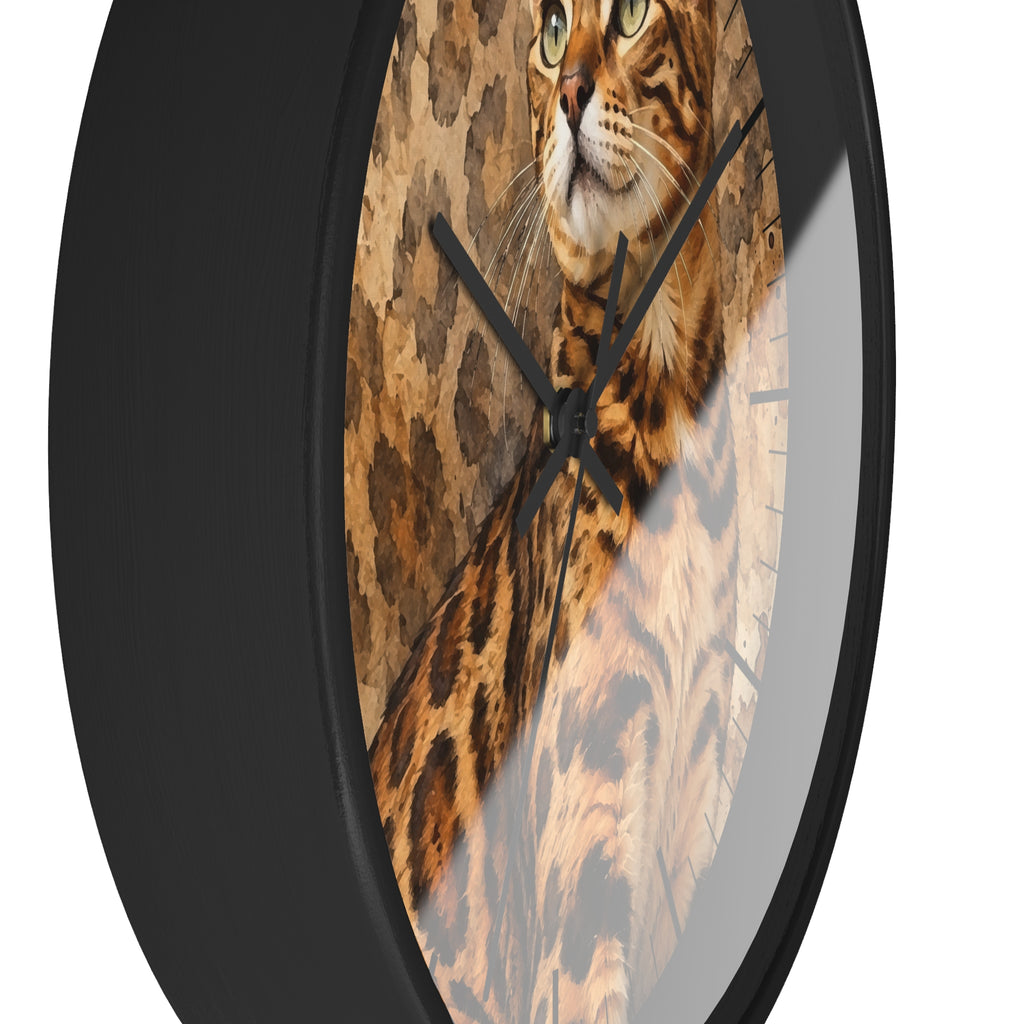 A round wall clock with a black frame and a printed cat face and fur design on the face, shown against a plain white background.