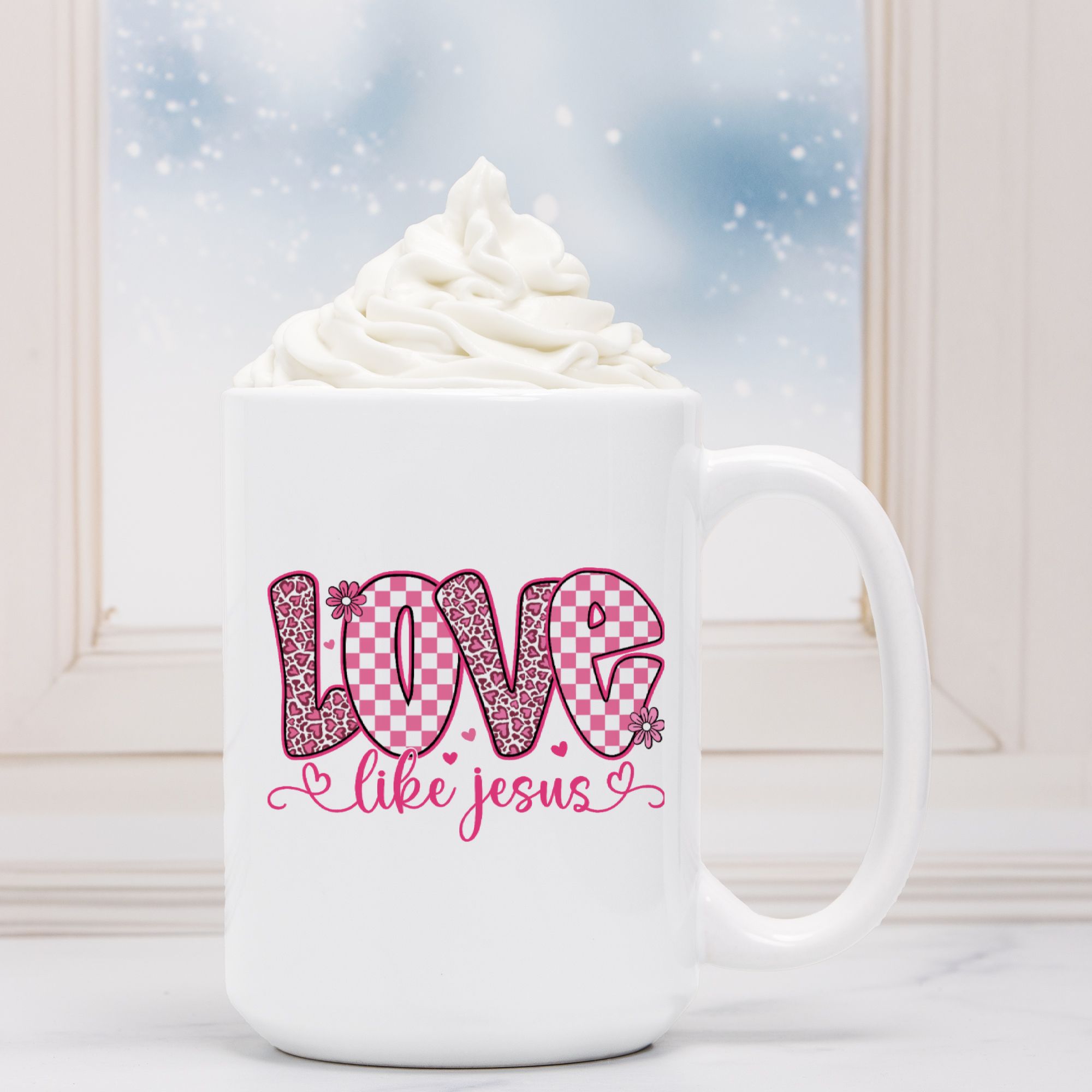 White mug with 'Love like Jesus' design on a white surface with a blurred background