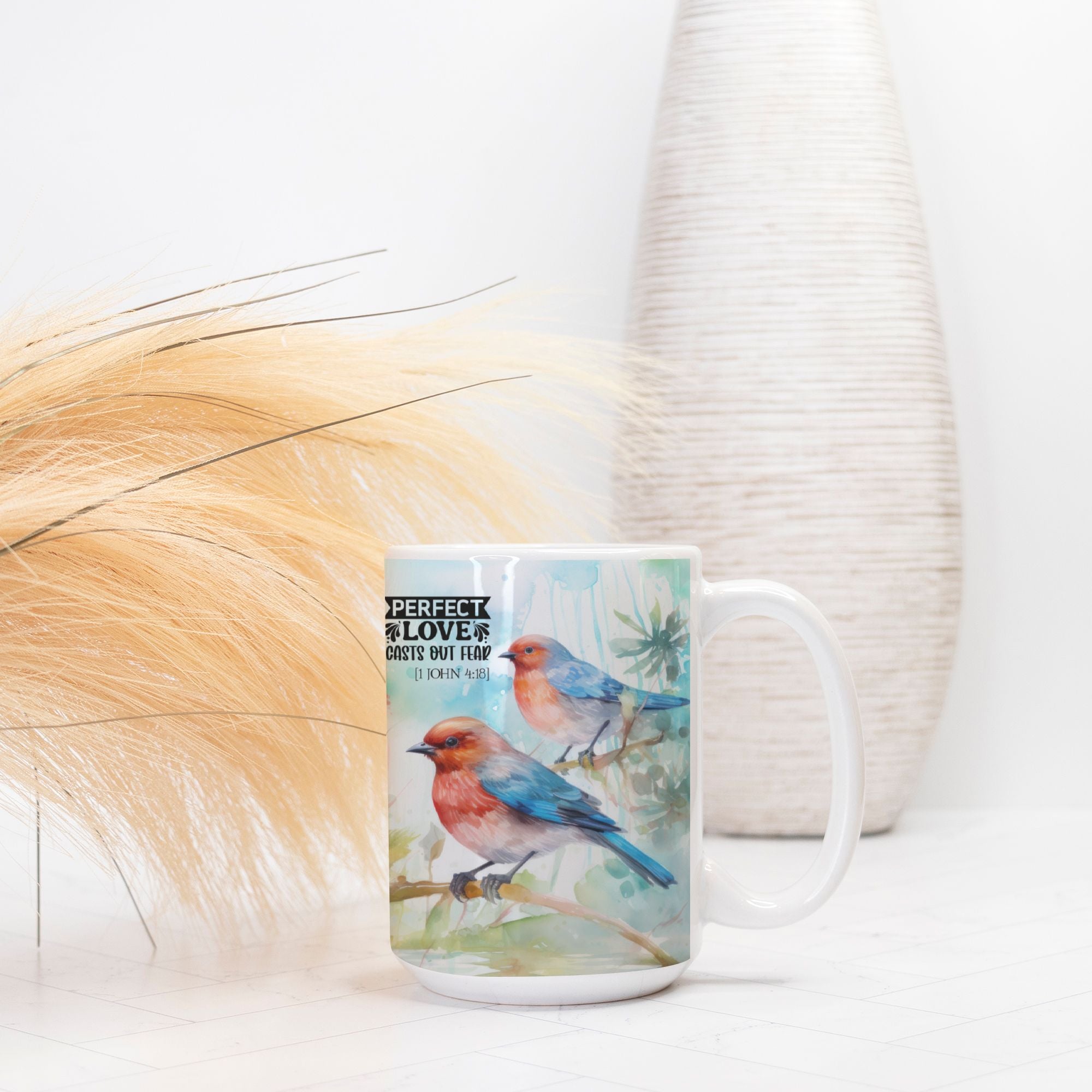 Mug with bird design and text on a white surface with decorative elements
